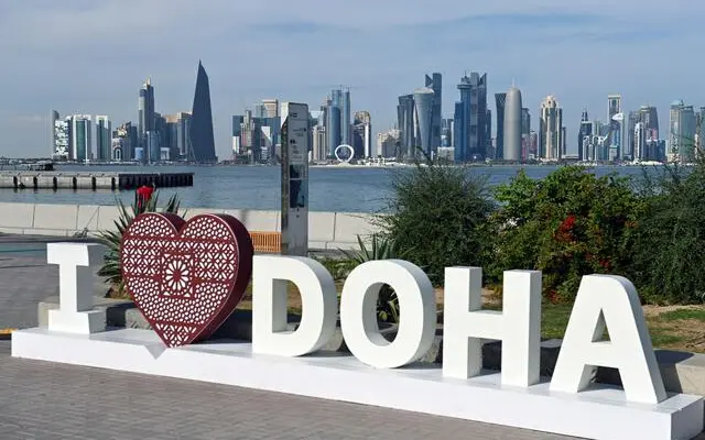 I Love Doha sign beside the water with the Doha skyline behind it.
