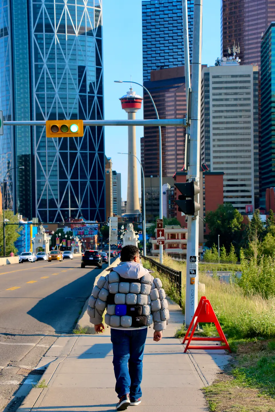Walking down a sunlit street toward downtown Calgary in the keyboard jacket.